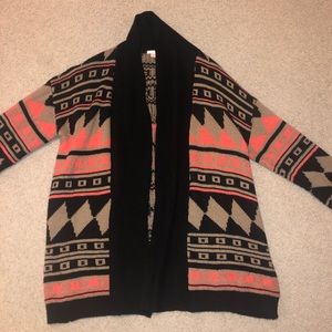 A tan, black, and vibrant peach color cardigan!